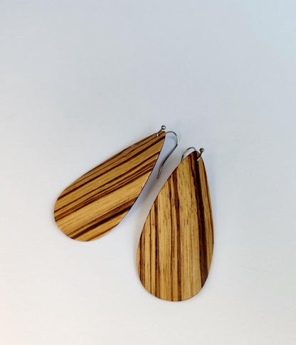 Tear-drop wooden dangle earrings with a natural striped wood grain pattern, shown on a plain light background.